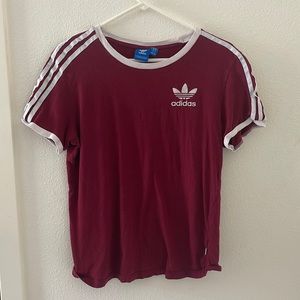 Burgundy adidas brand shirt with white stripes